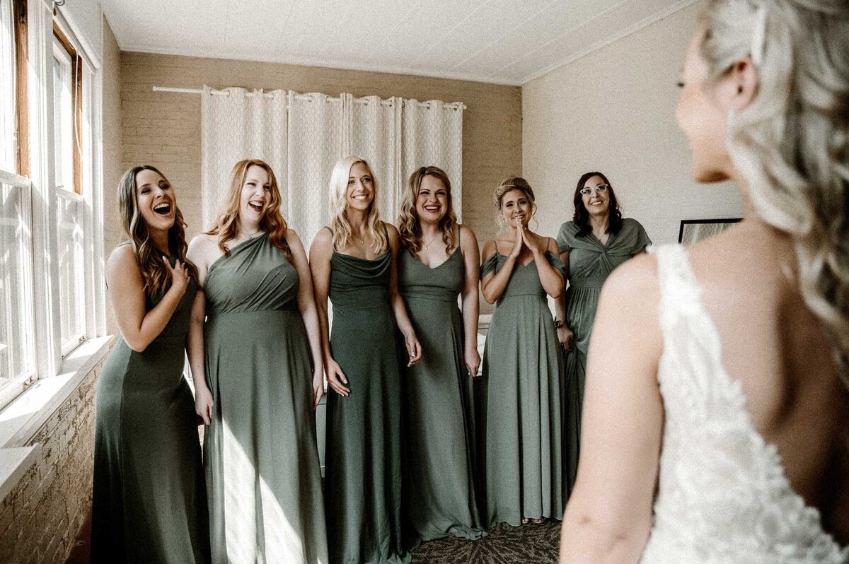 first-look-with-bridesmaids-hotel-room-st-louis-missouri