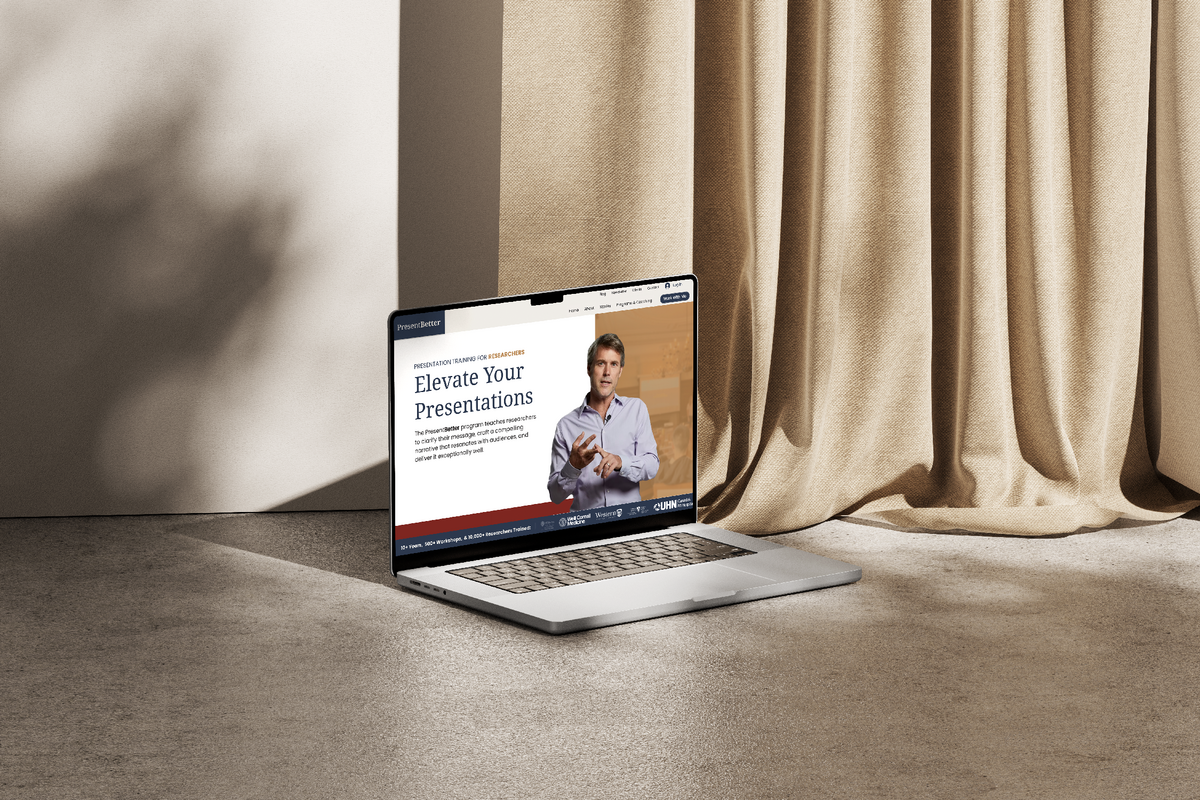 Laptop Mockup showcasing the website design of a Phd Presentation Coach against a cream wall with curtains