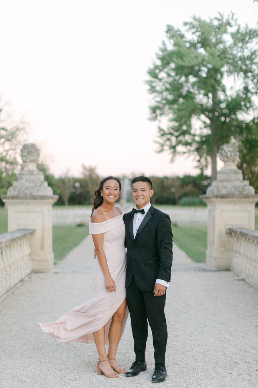 Wedding guests posing at luxury Provence celebration – elegant evening attire captured in natural light.