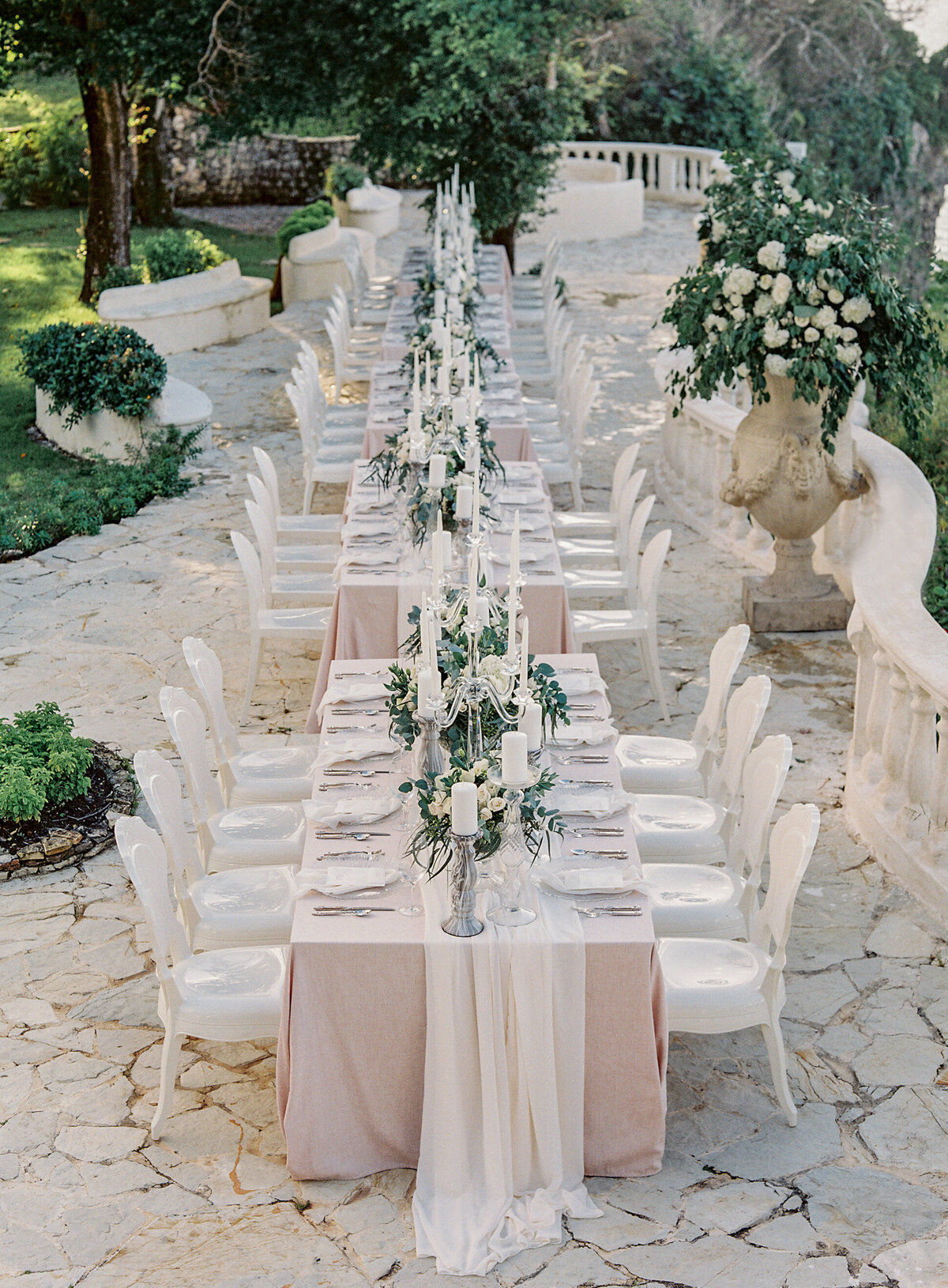 An elegant outdoor wedding reception setup at a top tropical destination venue in the Caribbean, Dominican Republic, beautifully captured by photographer Laura Gordon.