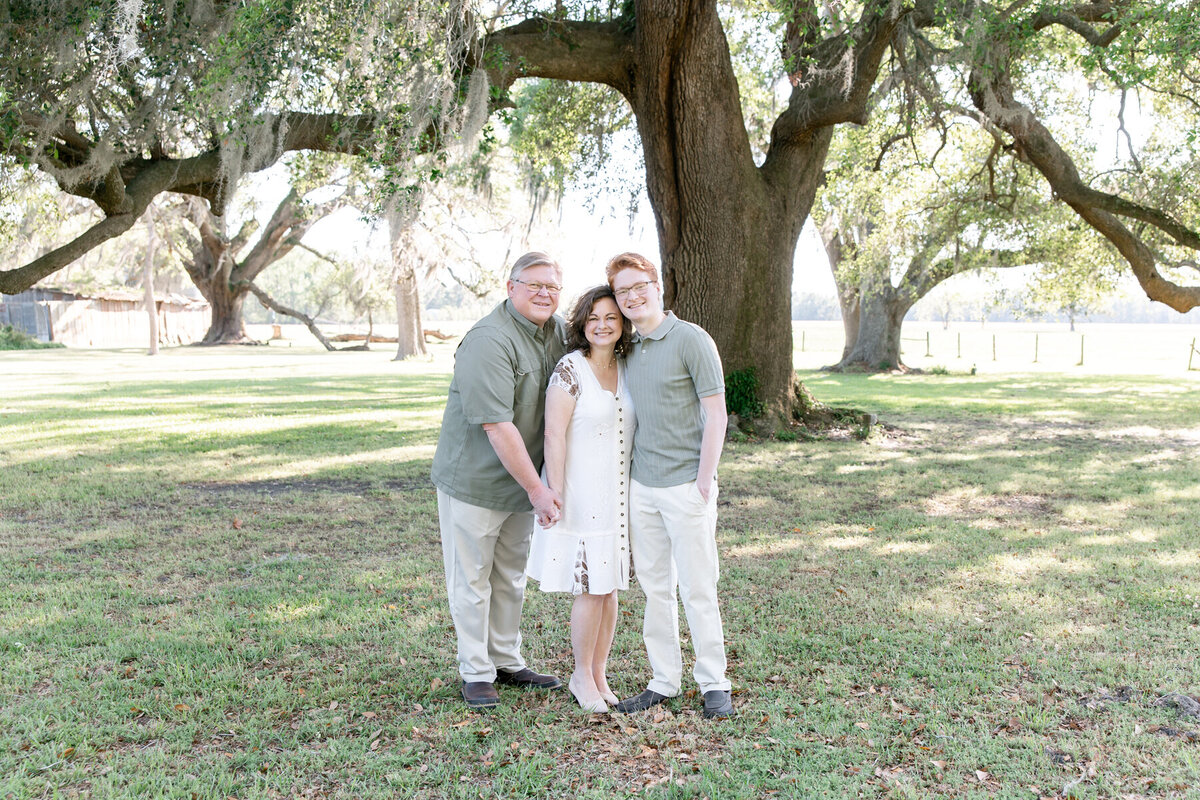 family all looking at newborn baby by Savannah family photographer Tiffany Bradley