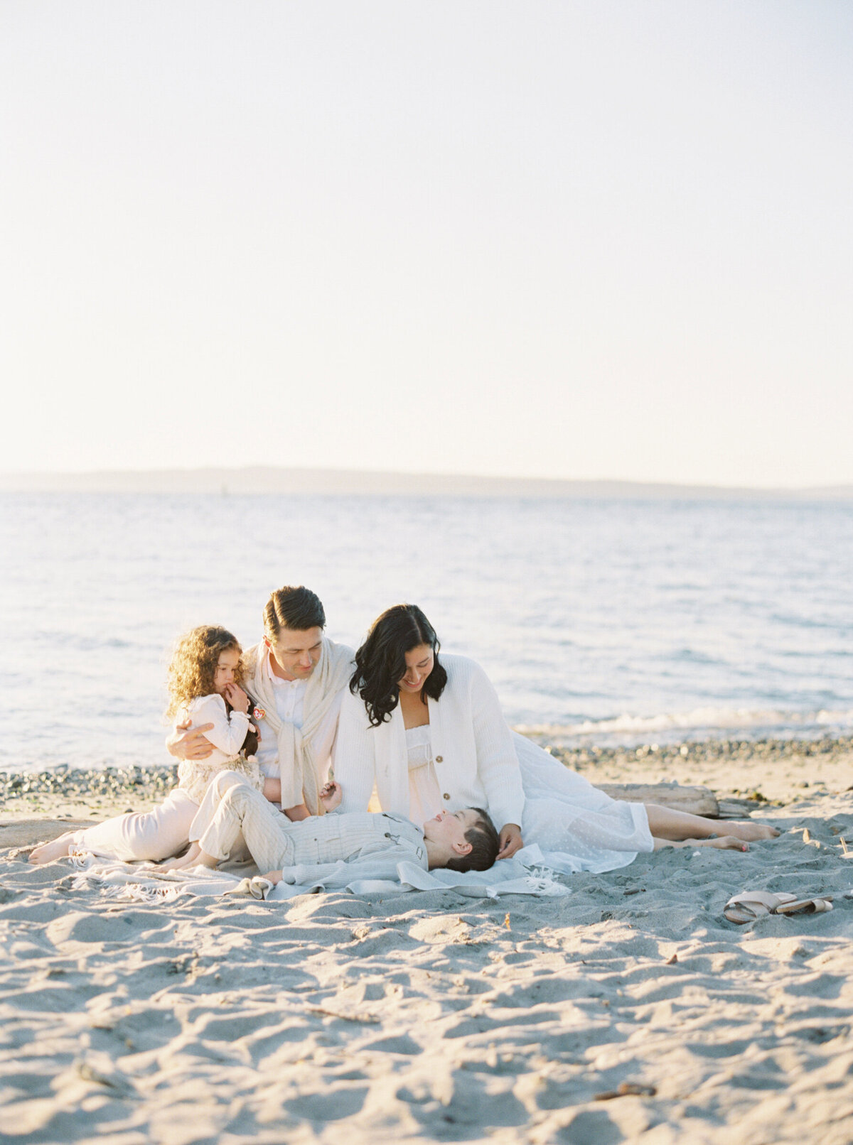 Family Photos Seattle at golden hour on the beach family all in white.