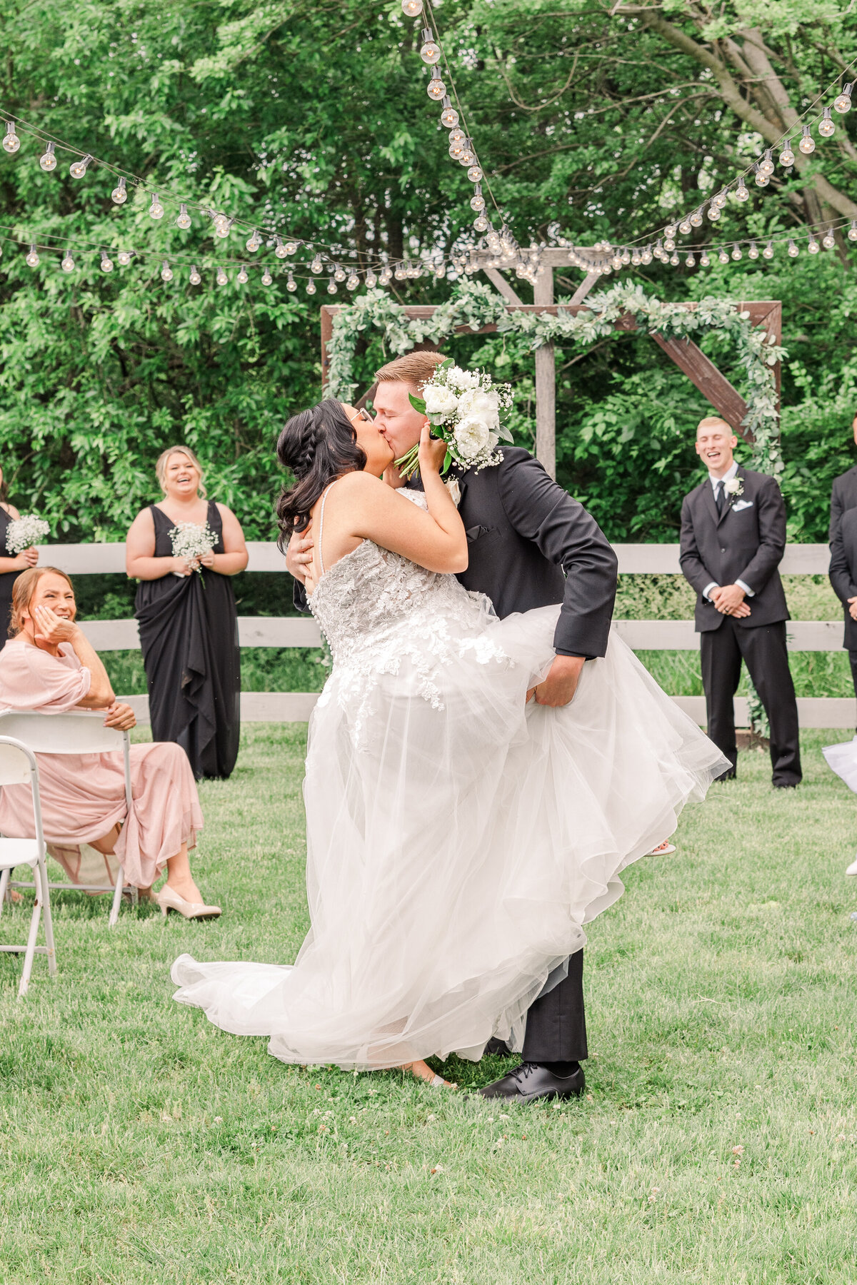 Bride and groom dip halfway down the aisle after ceremony in Harrodsburg