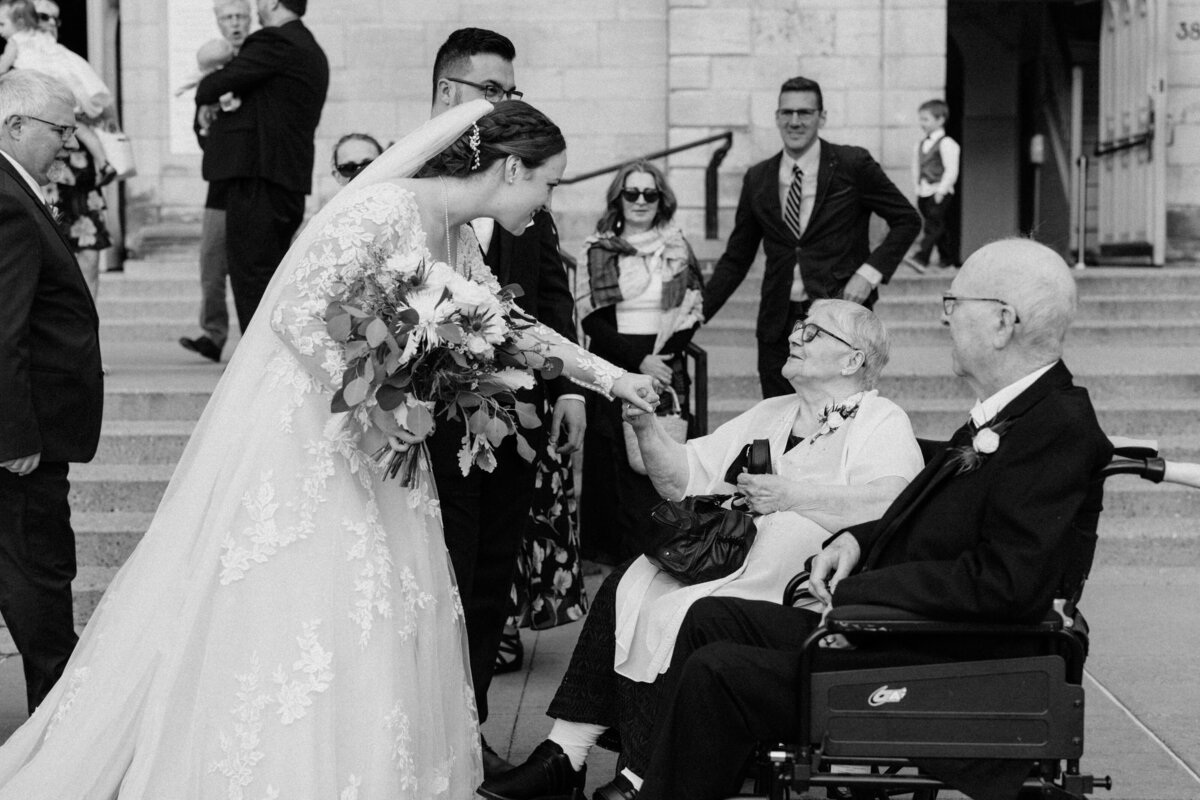 The bride and groom greeting their grandparents after the wedding