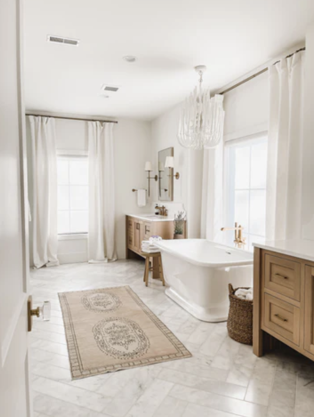Marble floors, an oversized free-standing tub and his and hers vanities make the primary bathroom a luxury retreat