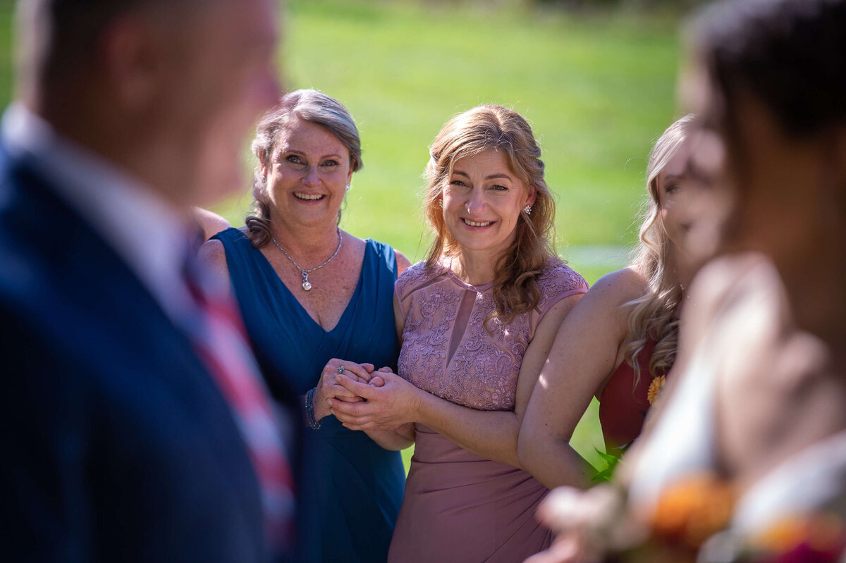 a mother of the bride smiles lovingly at her daughter as she gets ready for her wedding at Strathmere wedding venue in Ottawa