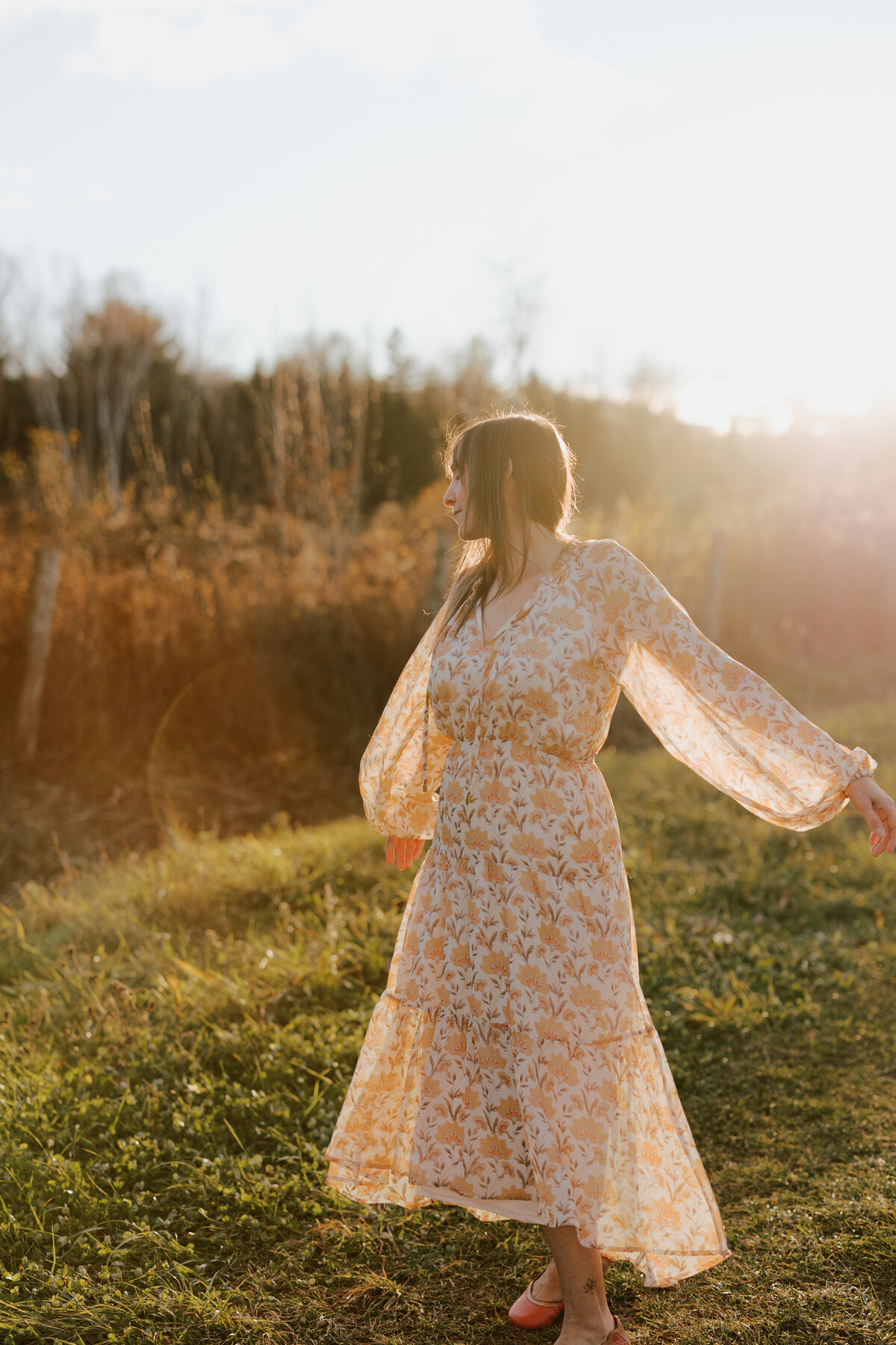 Julie dancing in the fields, with the sun as a great lighting