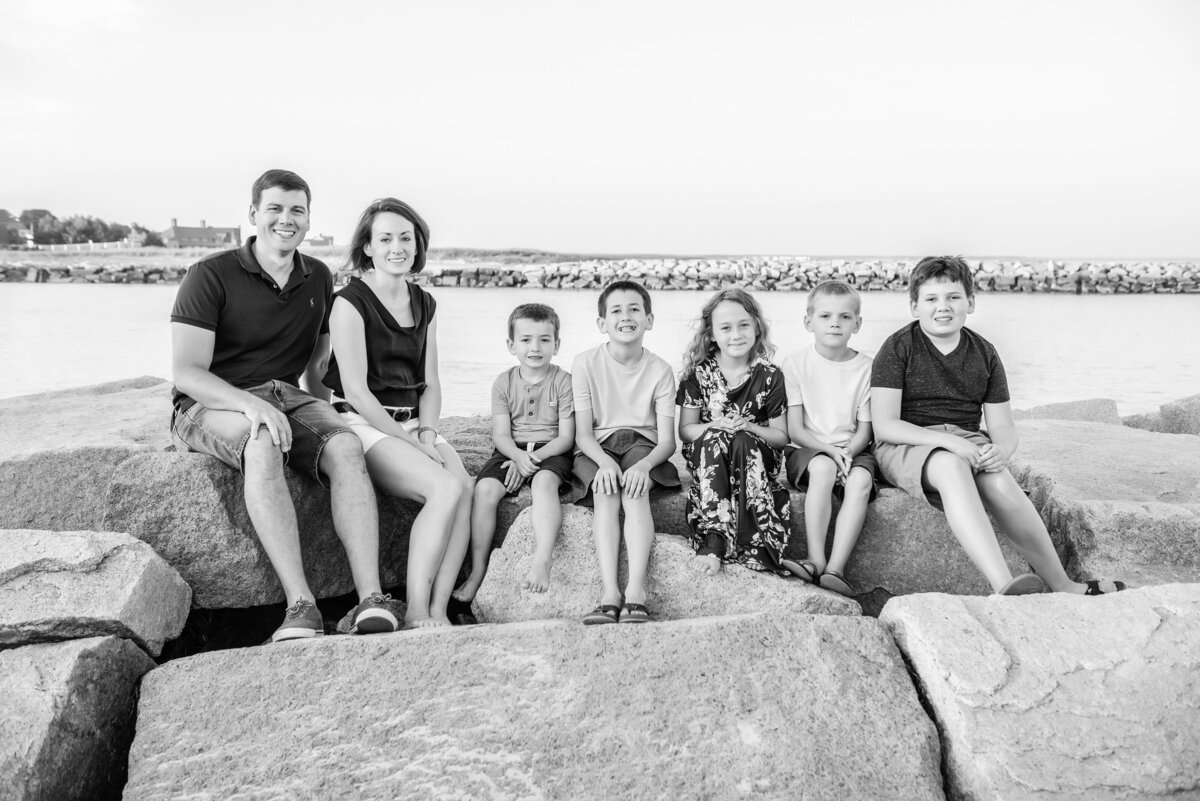 Family sitting on Wells Beach Jetty