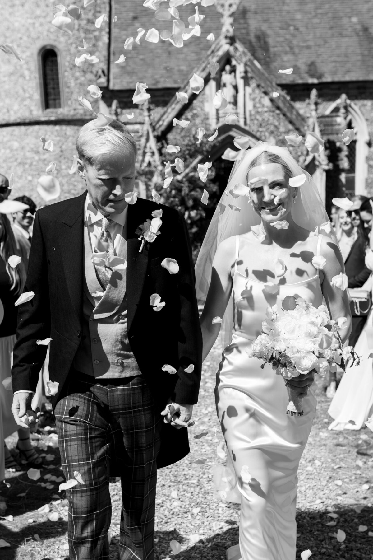 Confetti moment outside Welford Park church wedding, luxury editorial wedding photography UK by The Falkenburgs Studio