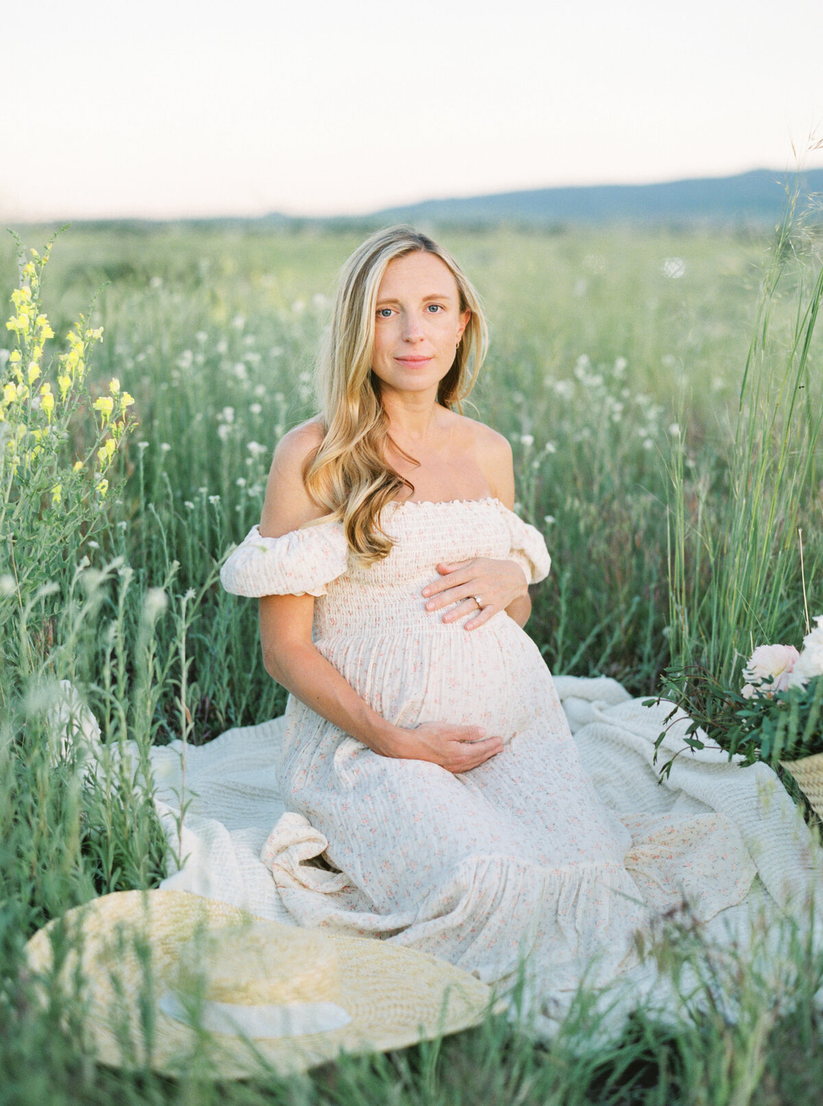 Boulder photographer featuring maternity photography session in a field.