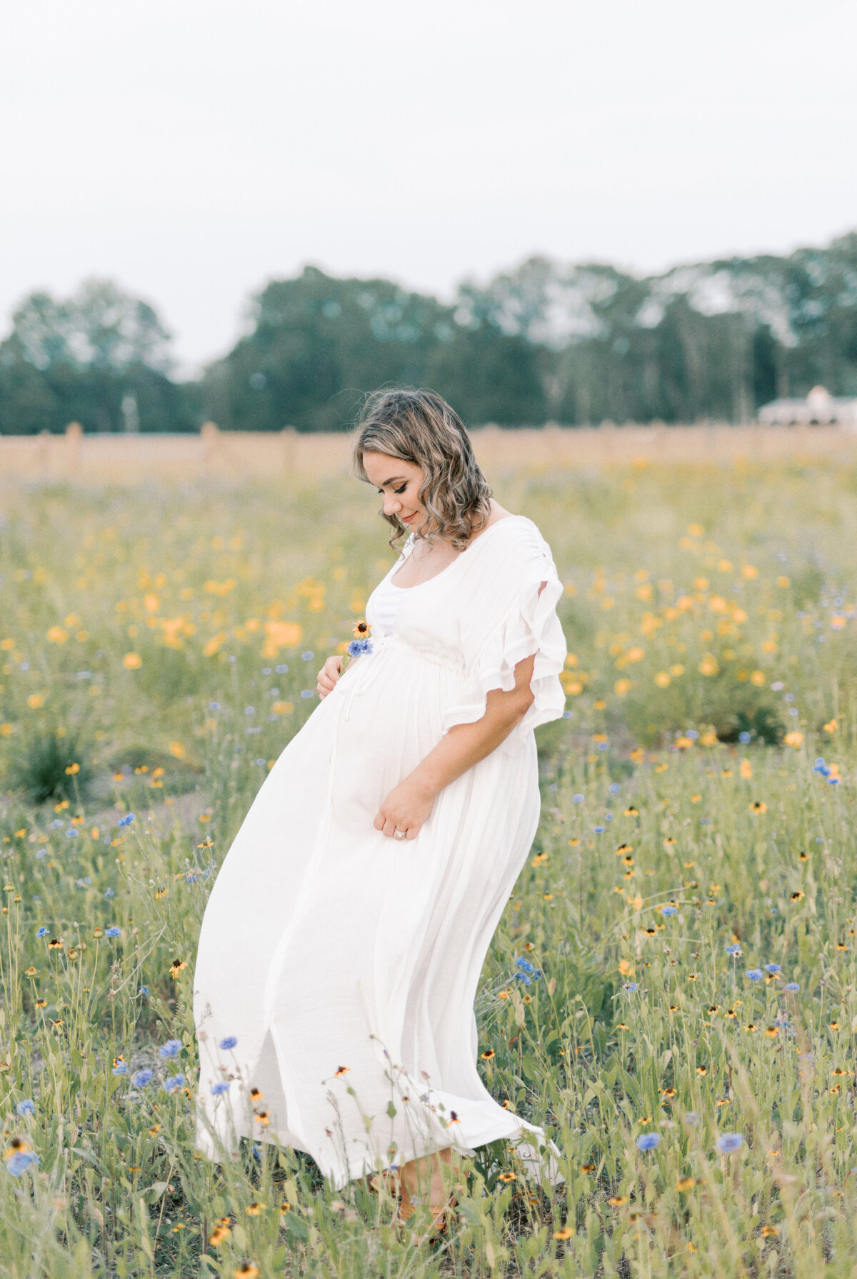 pregnant women holding belly and swaying dress