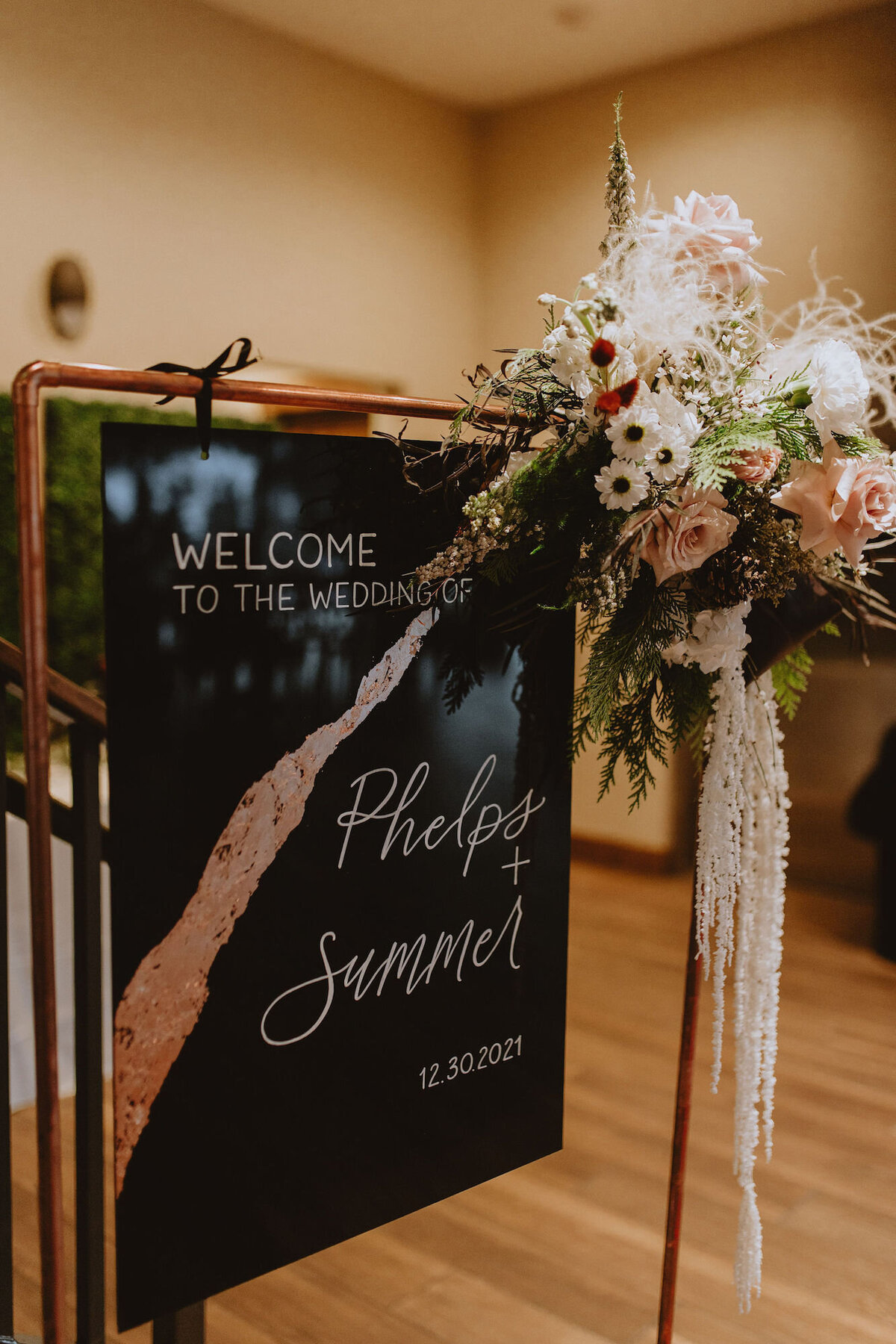 Black and white wedding welcome sign with rose gold metallic streak and custom calligraphy