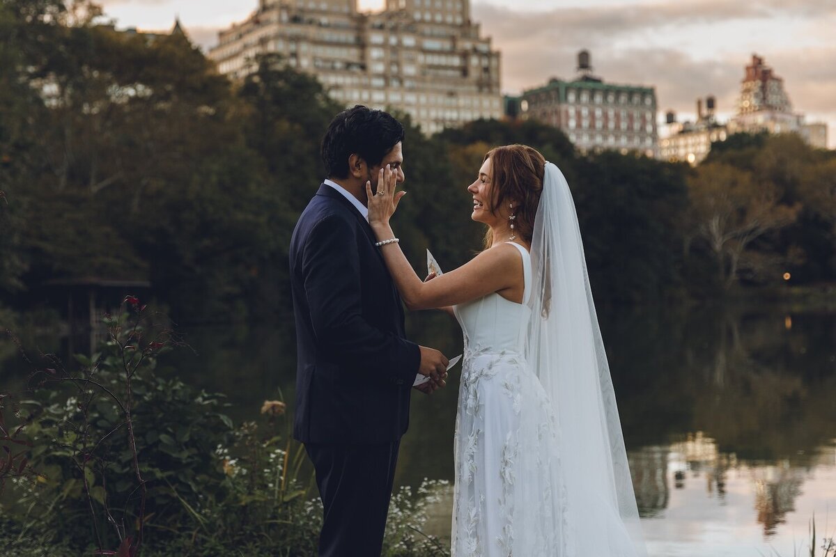 Bride touching groom’s face during heartfelt vow exchange