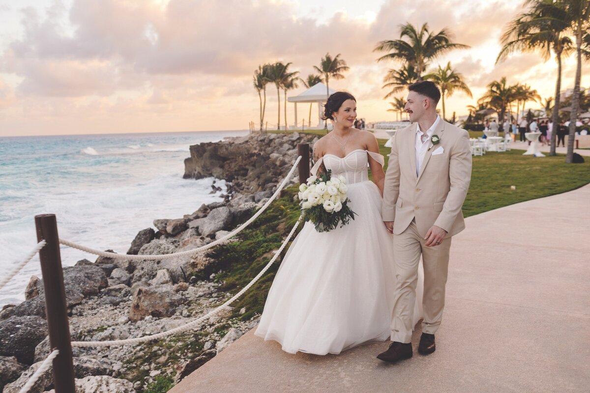 Bride and groom walking near the cliffs at Hyatt Ziva in Cancun wedding