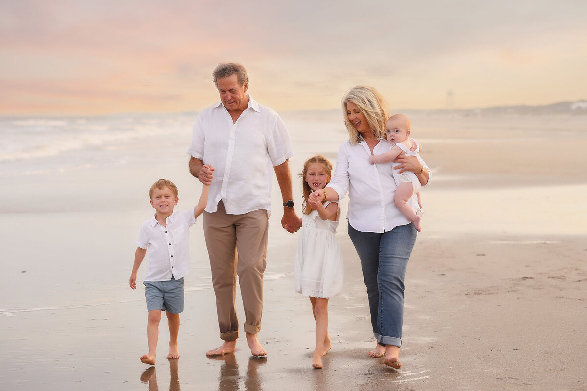 Grandparents walk with their grand children during Family Portraits on Isle of Palms.