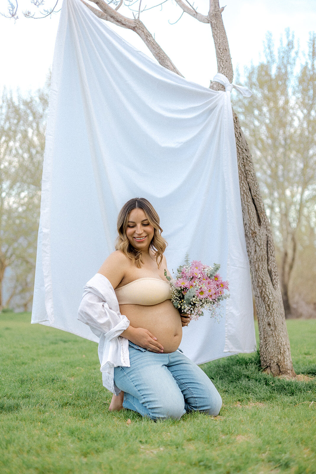 A pregnant woman is happy while holding her belly