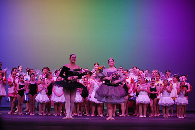 two seniors doing their ballet bows after the ballet production at recital
