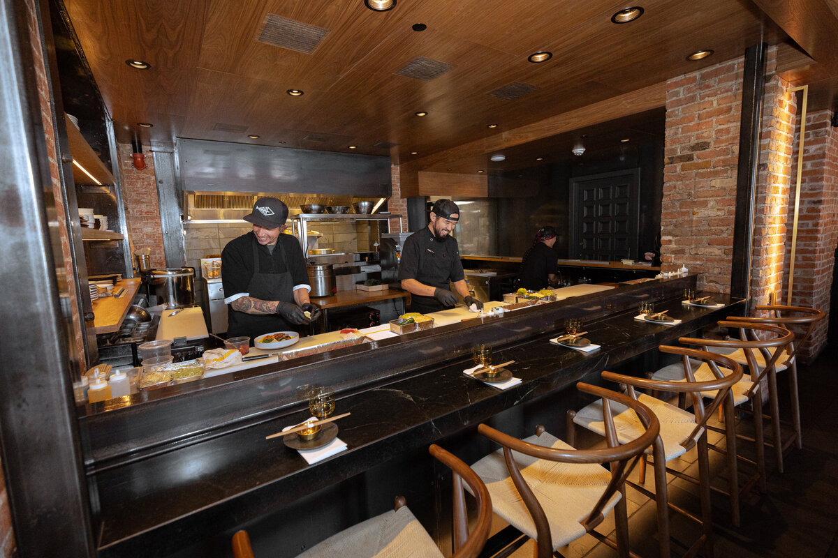 Two sushi chefs cut up fish at Sushi Row in Colorado Springs