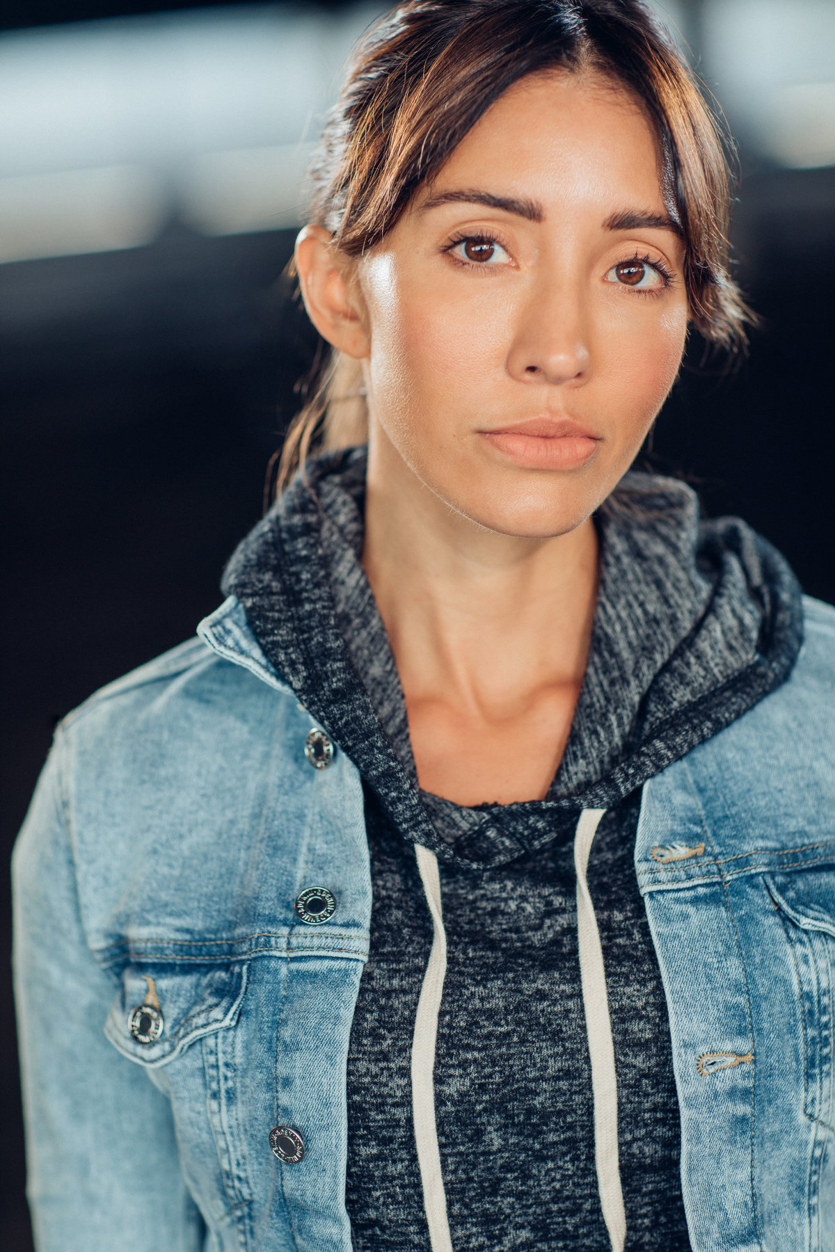 Headshot Photograph Of Young Woman In Outer Faded Denim Jacket And Inner Black Hoodie Los Angeles