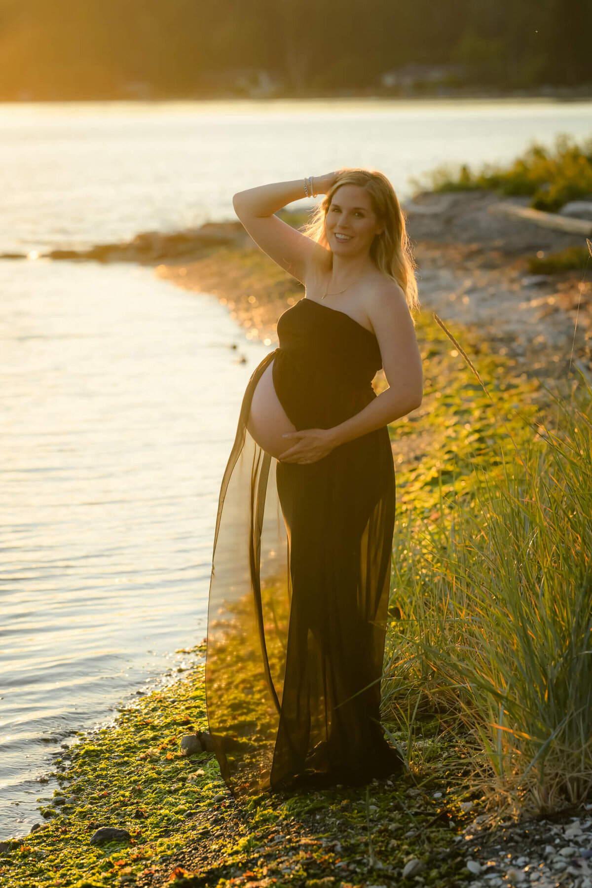 Beth Benecki captures this mom-to-be glows in a sheer black dress, framed by the warm hues of the setting sun.
