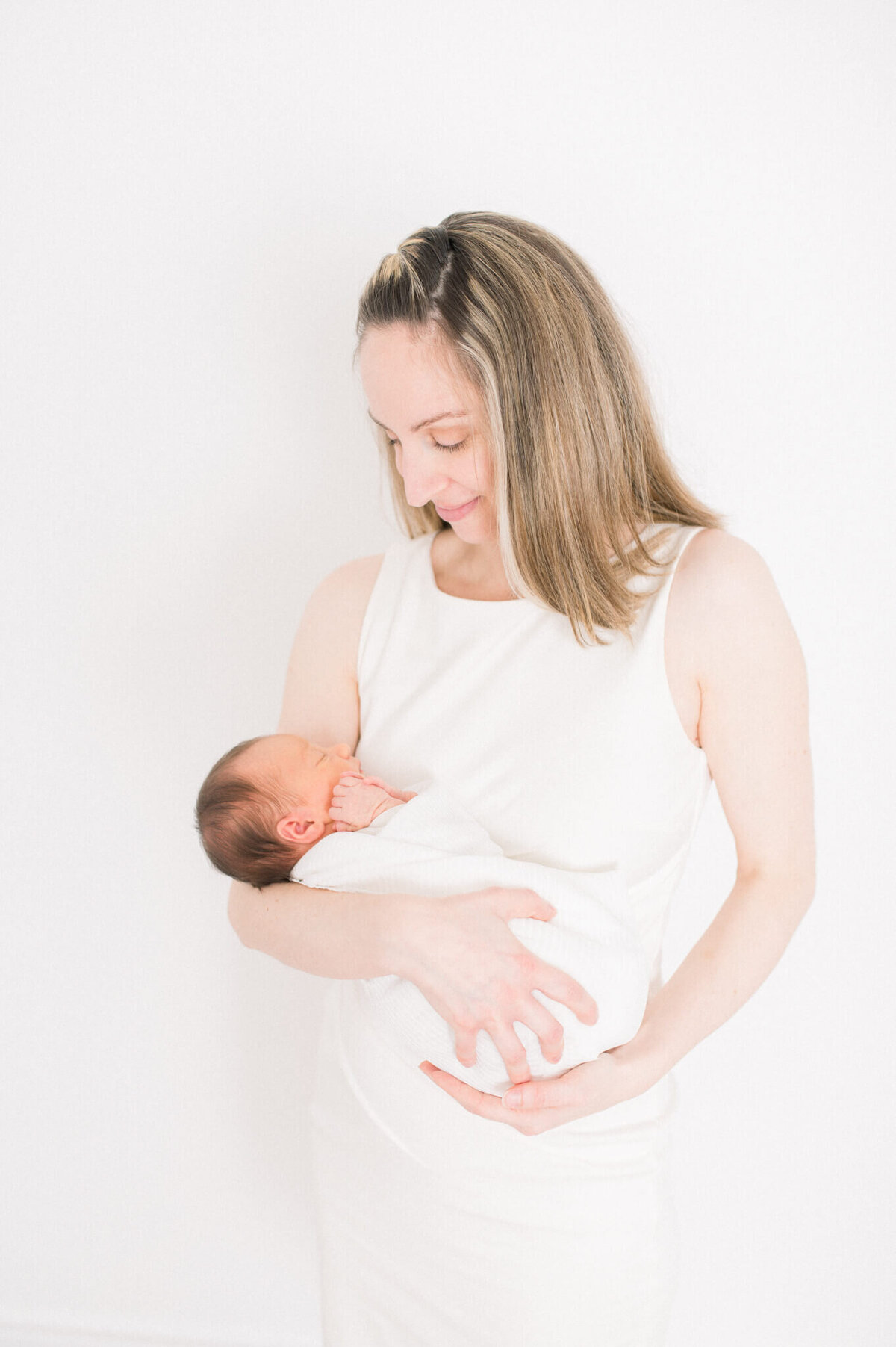 Niagara newborn photography of white and bright studio session of mom and baby