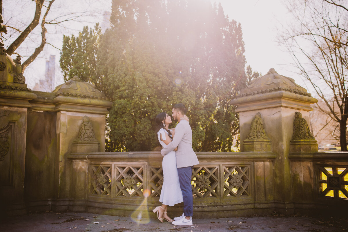 A couple sharing a moment at central park mall near bethesda terrace