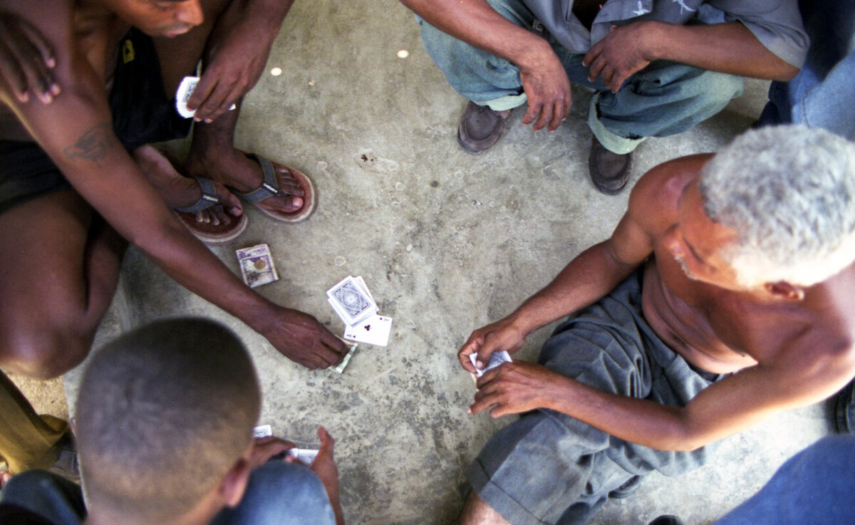 A group of men sit to play cards in Santo Domingo