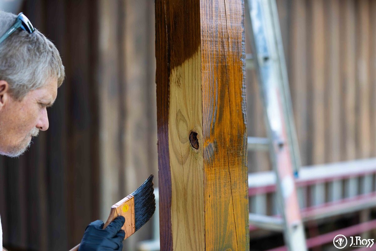 photo of j.ross painter staining deck near johnson city