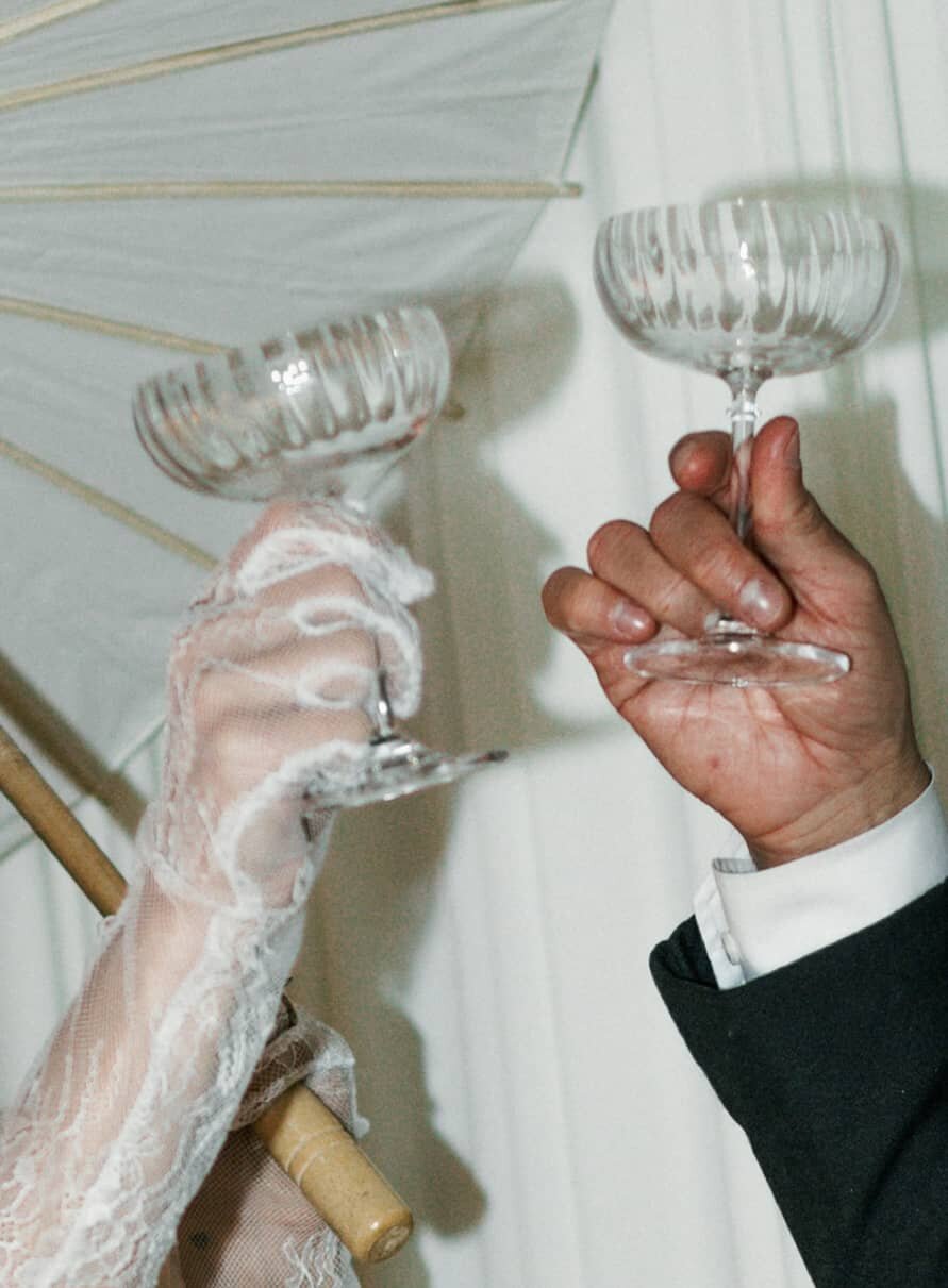 Champagne tower at wedding reception, cinematic celebration photography.