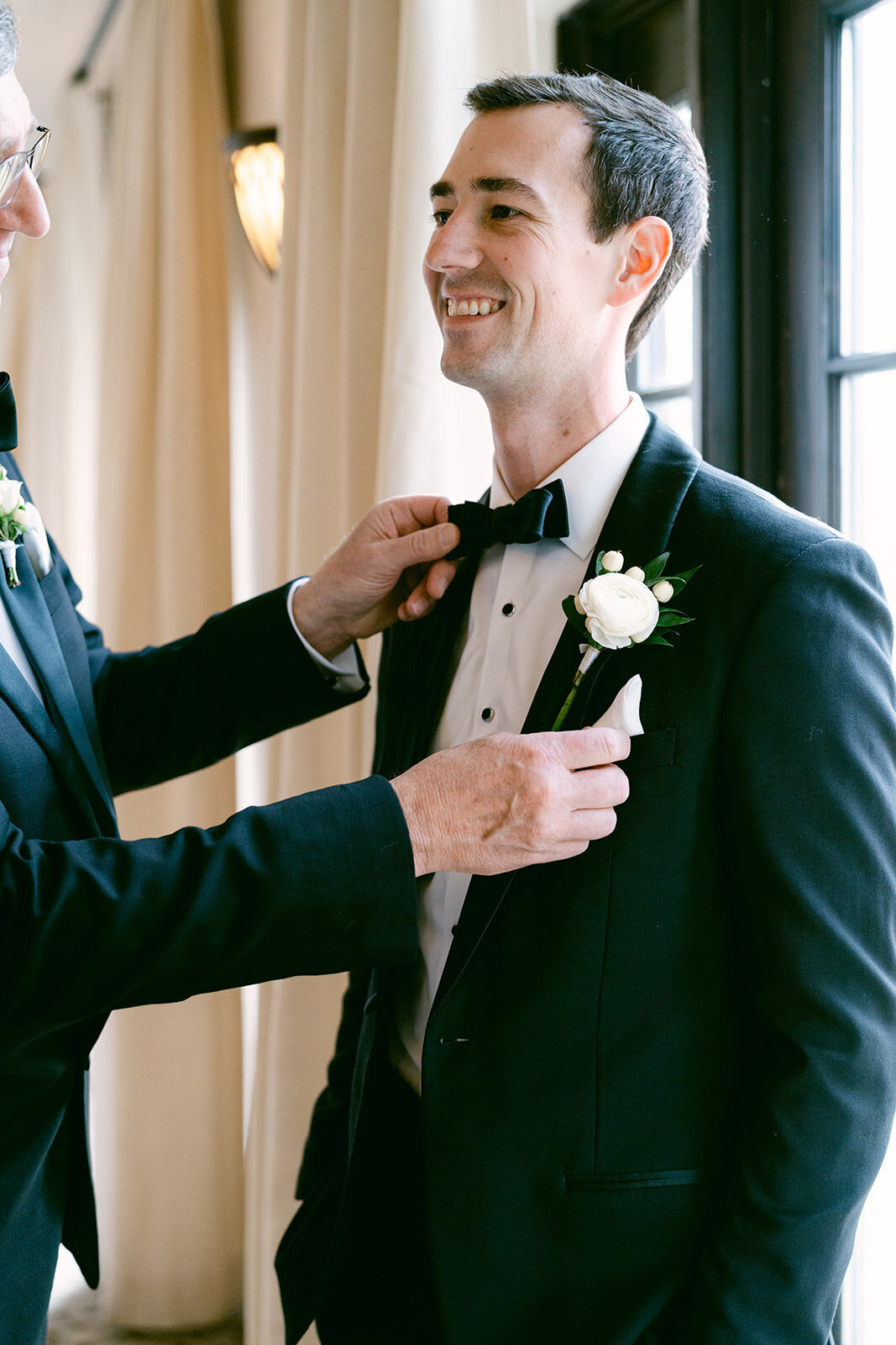 father of bride helping groom