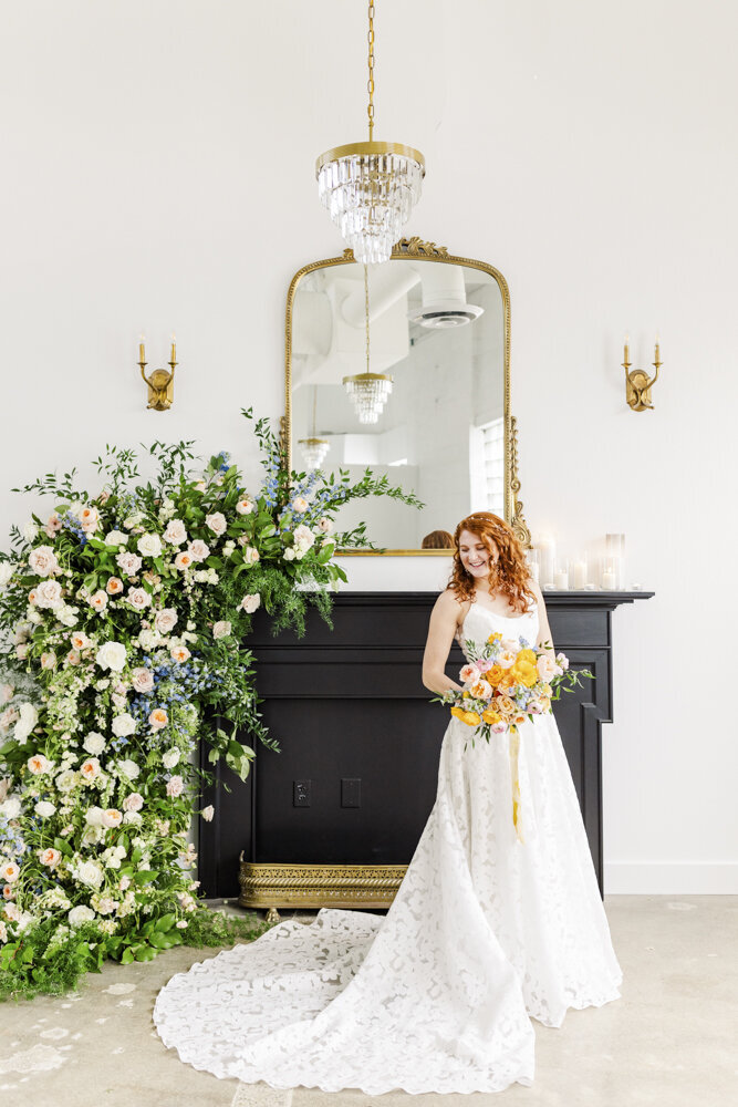 bride smiling in front of a fireplace