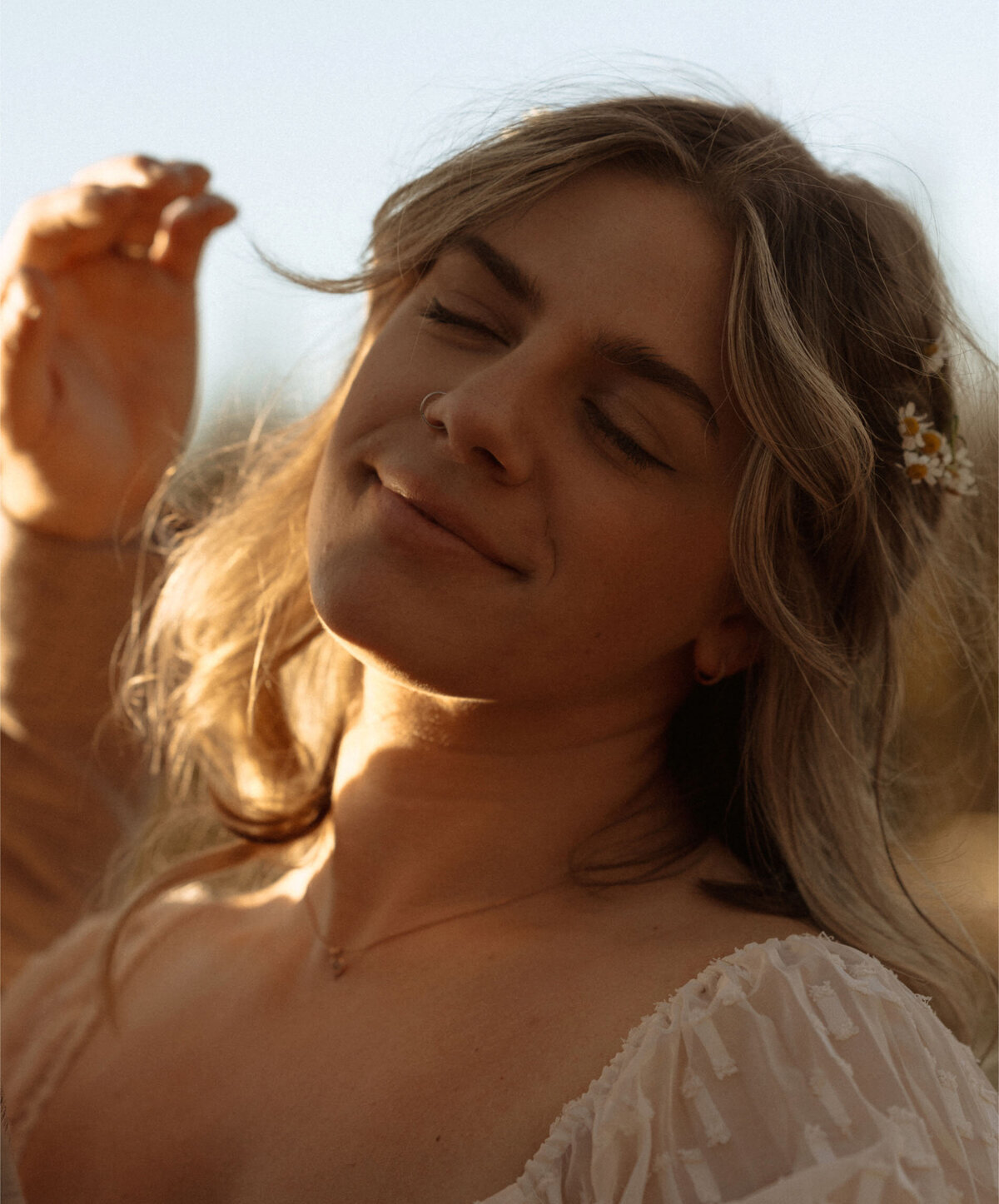 bride smiles sweetly as groom brushes hair away from her face in Bend, OR