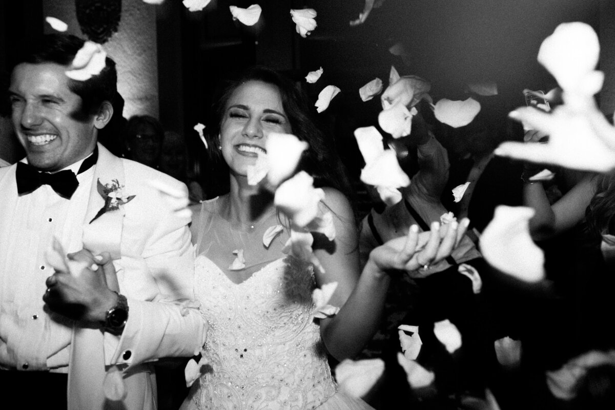 Bride and groom happily exiting their wedding reception