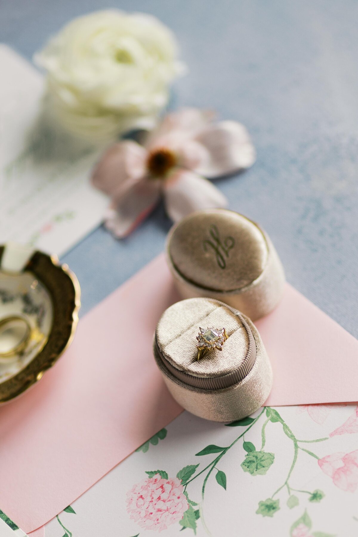 Close-up of wedding rings styled with florals at Dallas wedding
