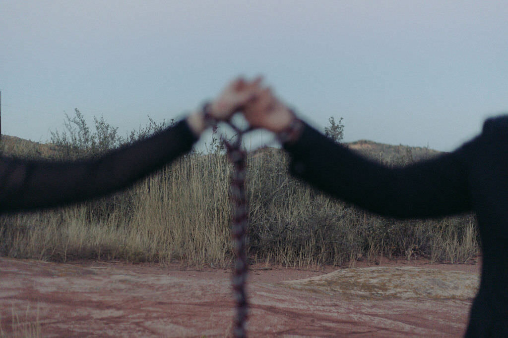 A rope holding two people's hands together.