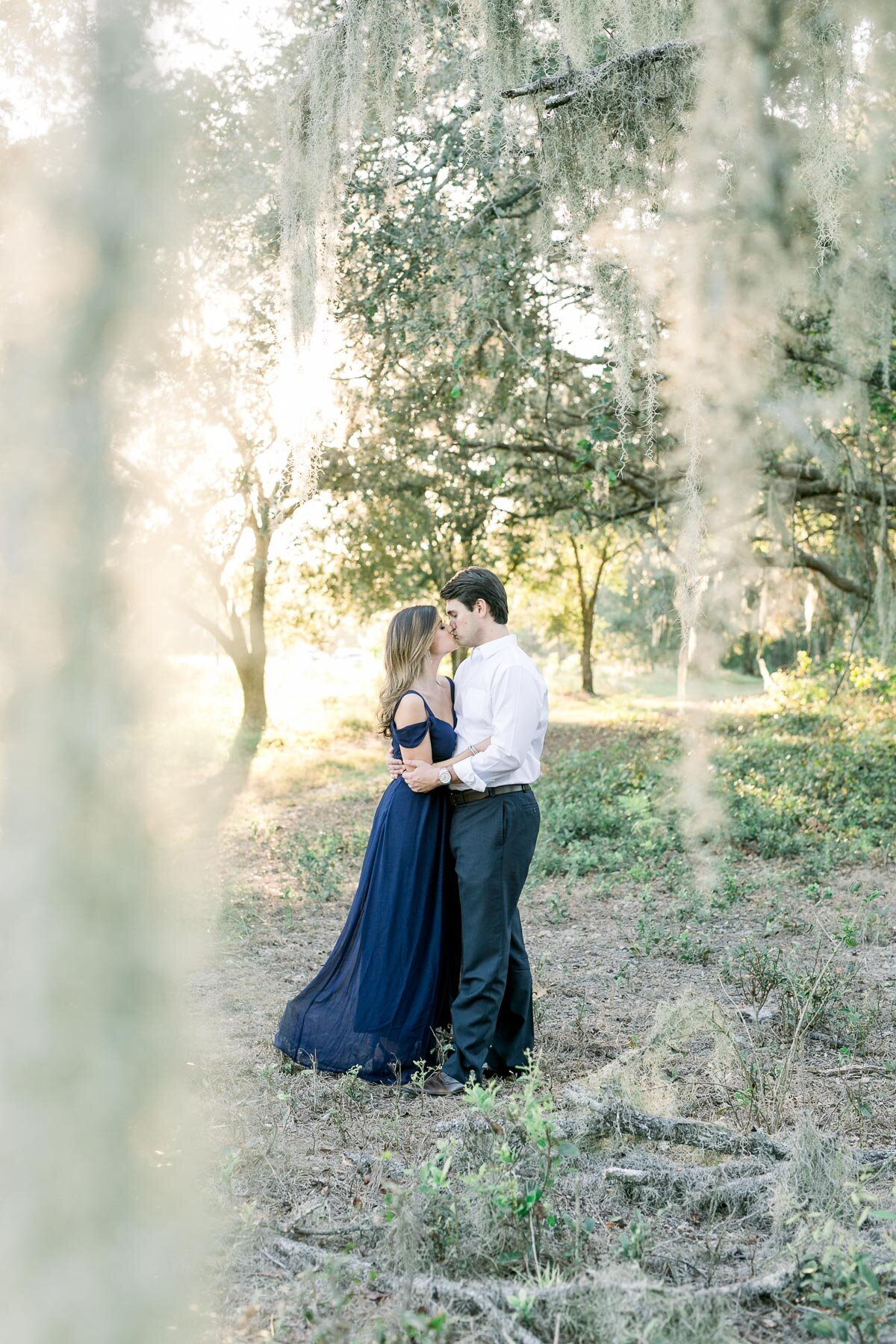 couple kissing under moss tree