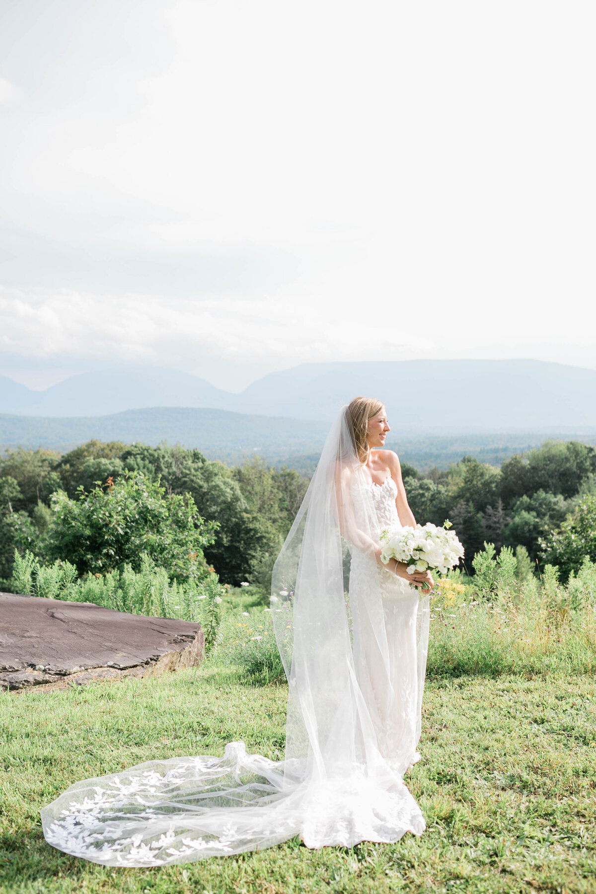 Bride smiles and stands near the altar alone