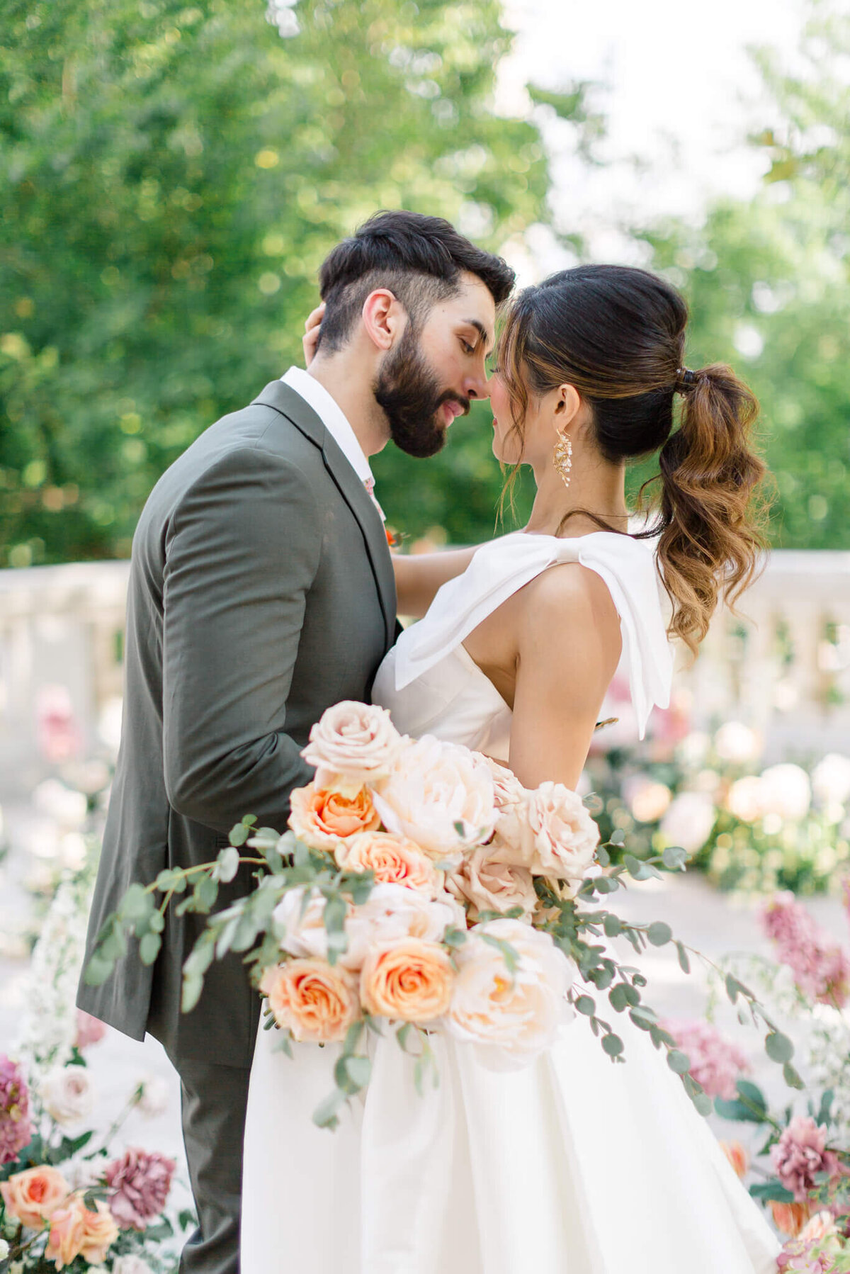 Bride and groom kissing on the portico at DAR Constitution Hall in Washington DC. Captured by Washington DC Wedding Photographer Bethany Aubre Photography.