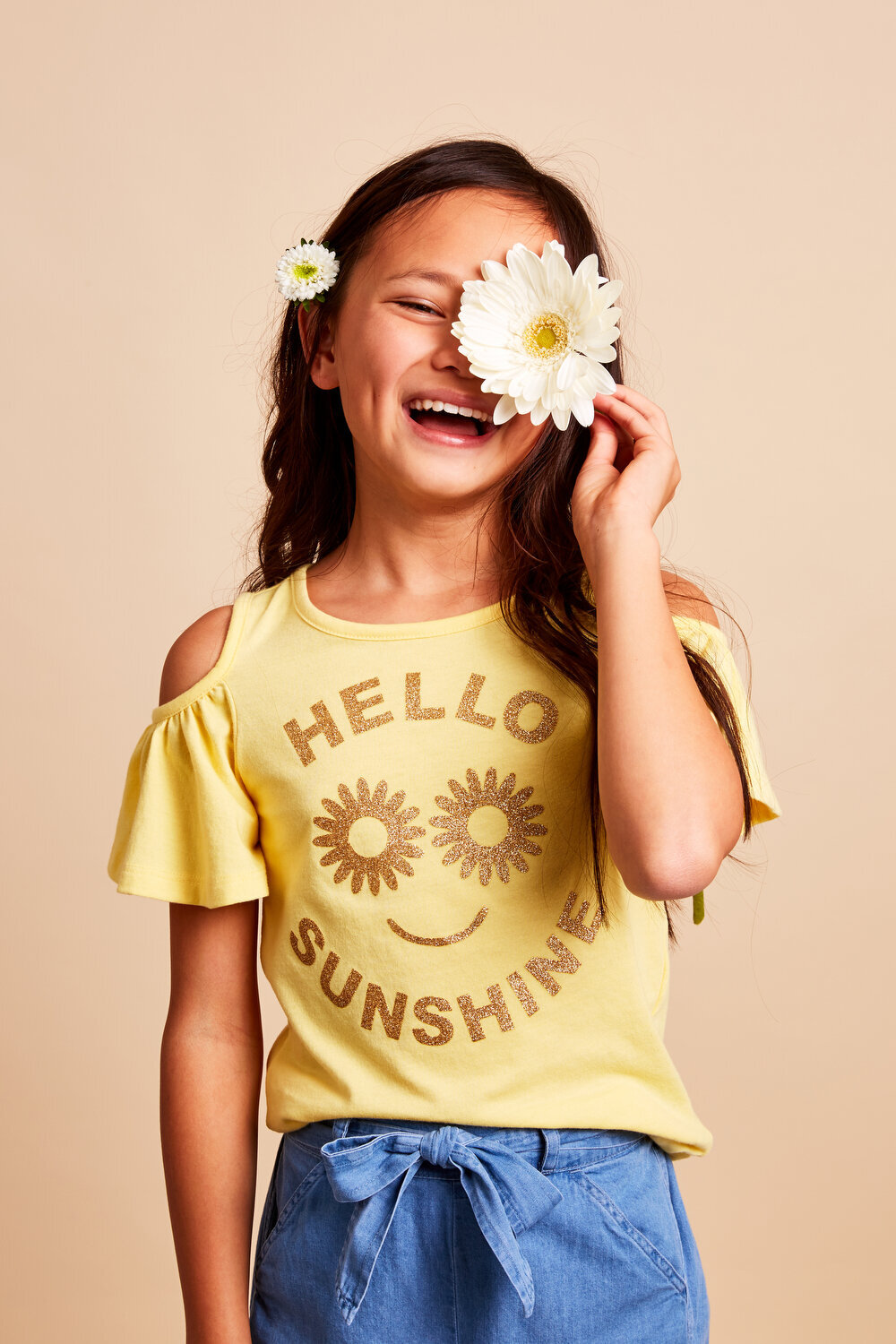 Greer Rivera Photography Kids Editorial Photoshoots Marin CA  Girl with "hello sunshine" t-shirt holding a flower in front of her eye