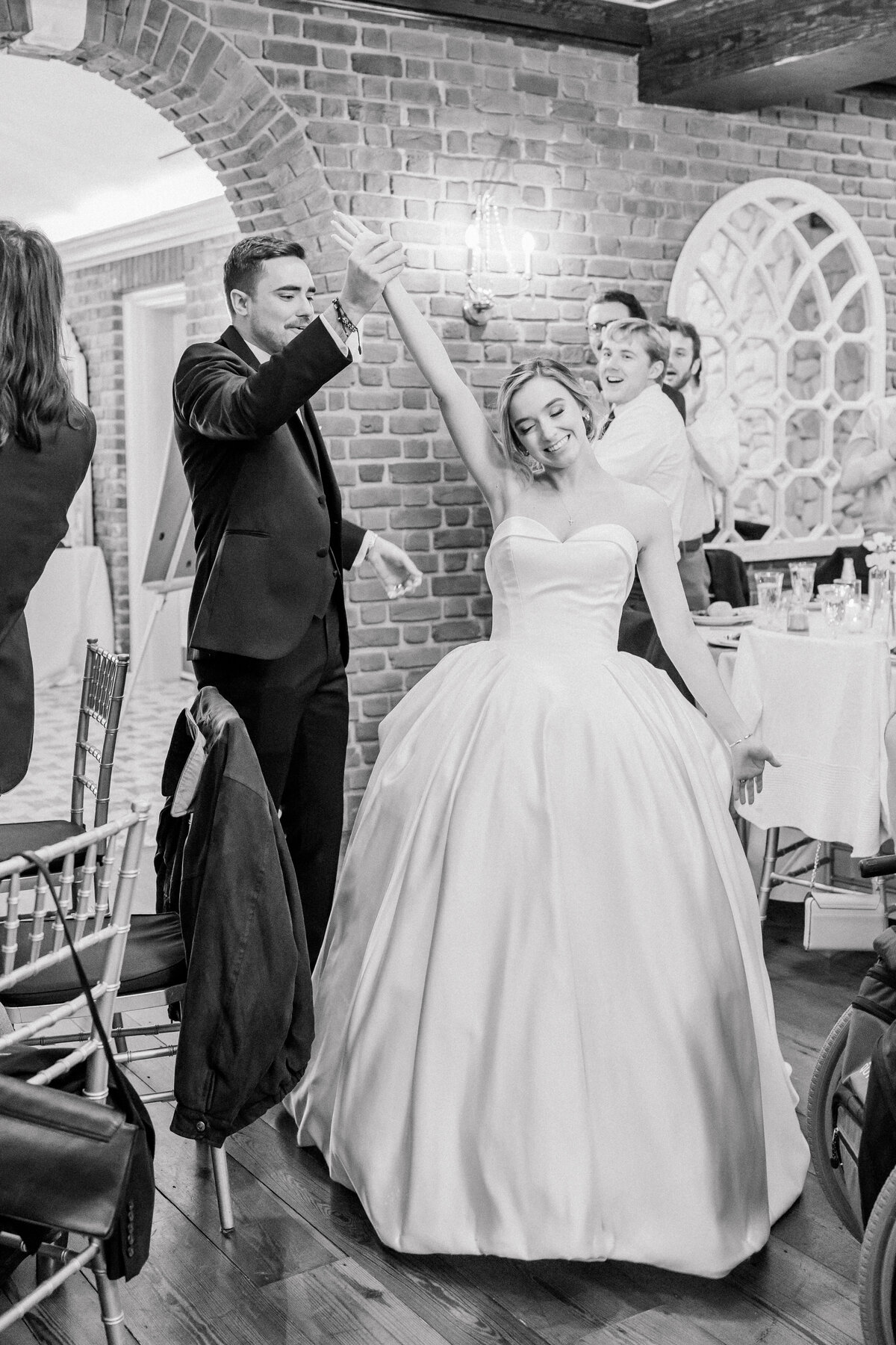 Bride and groom entrance to reception in black and white