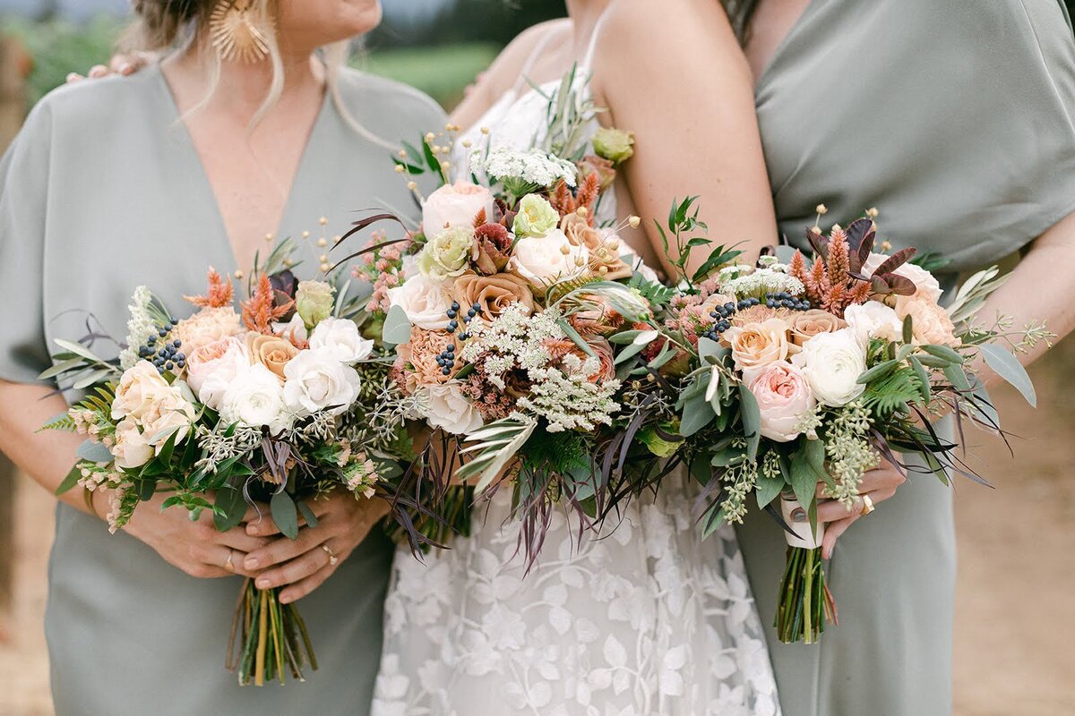 Wedding party bouquets featuring pastel and neutral color palette.