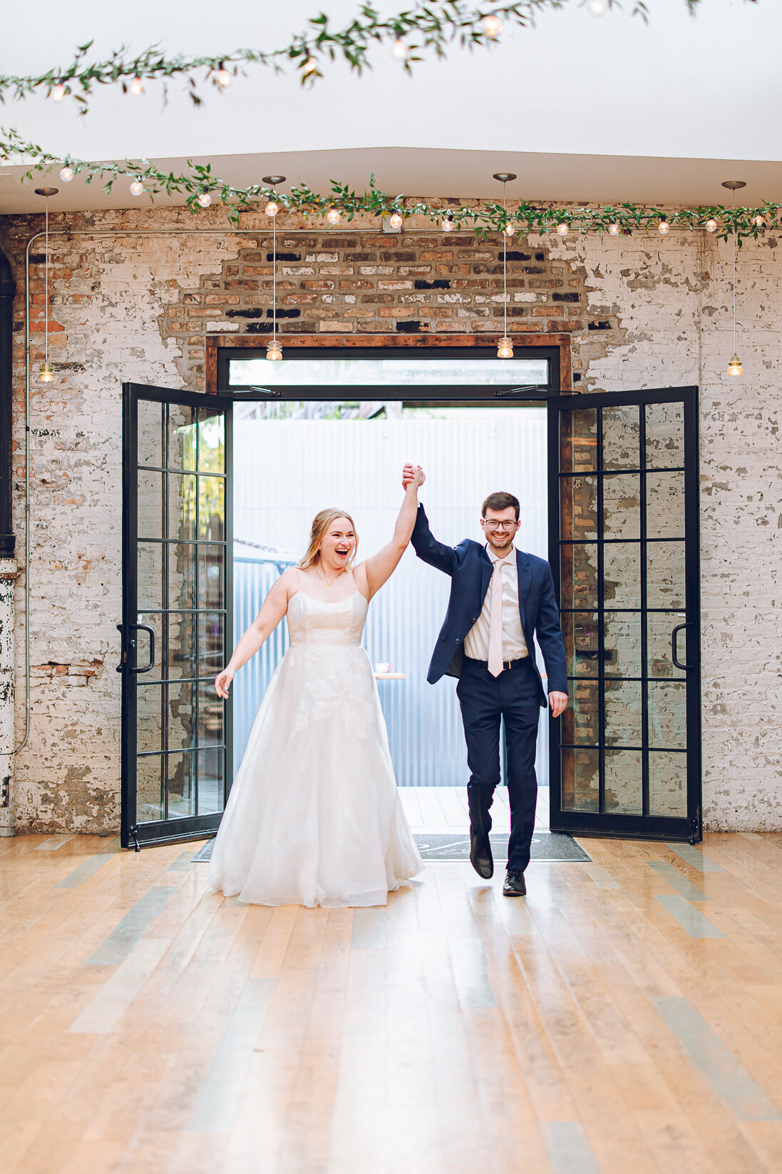 A couple make their grand entrance for their wedding reception at The Joinery in Chicago