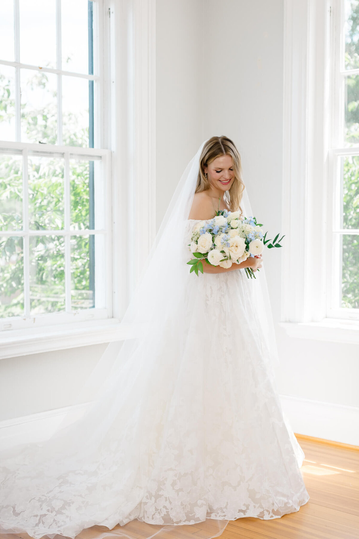 Bride cradling her wedding bouquet at The Inn at Vint Hill. Taken by Washington DC Wedding Photographer Bethany Aubre Photography.