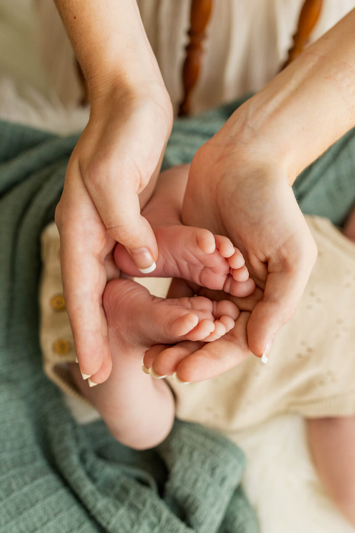 Mom holding newborn baby's feet