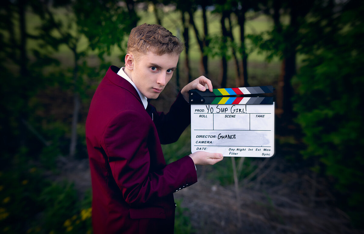 senior holding movie action sign