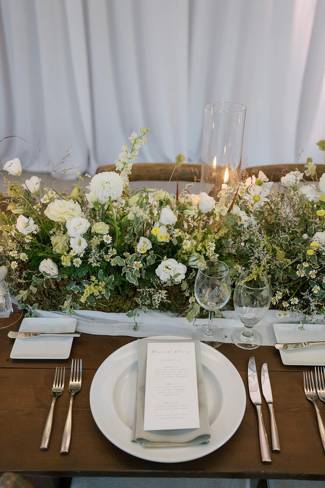 Wedding reception table at Aspen Meadows Resort, featuring elegant place settings, floral arrangements, and soft candlelight.