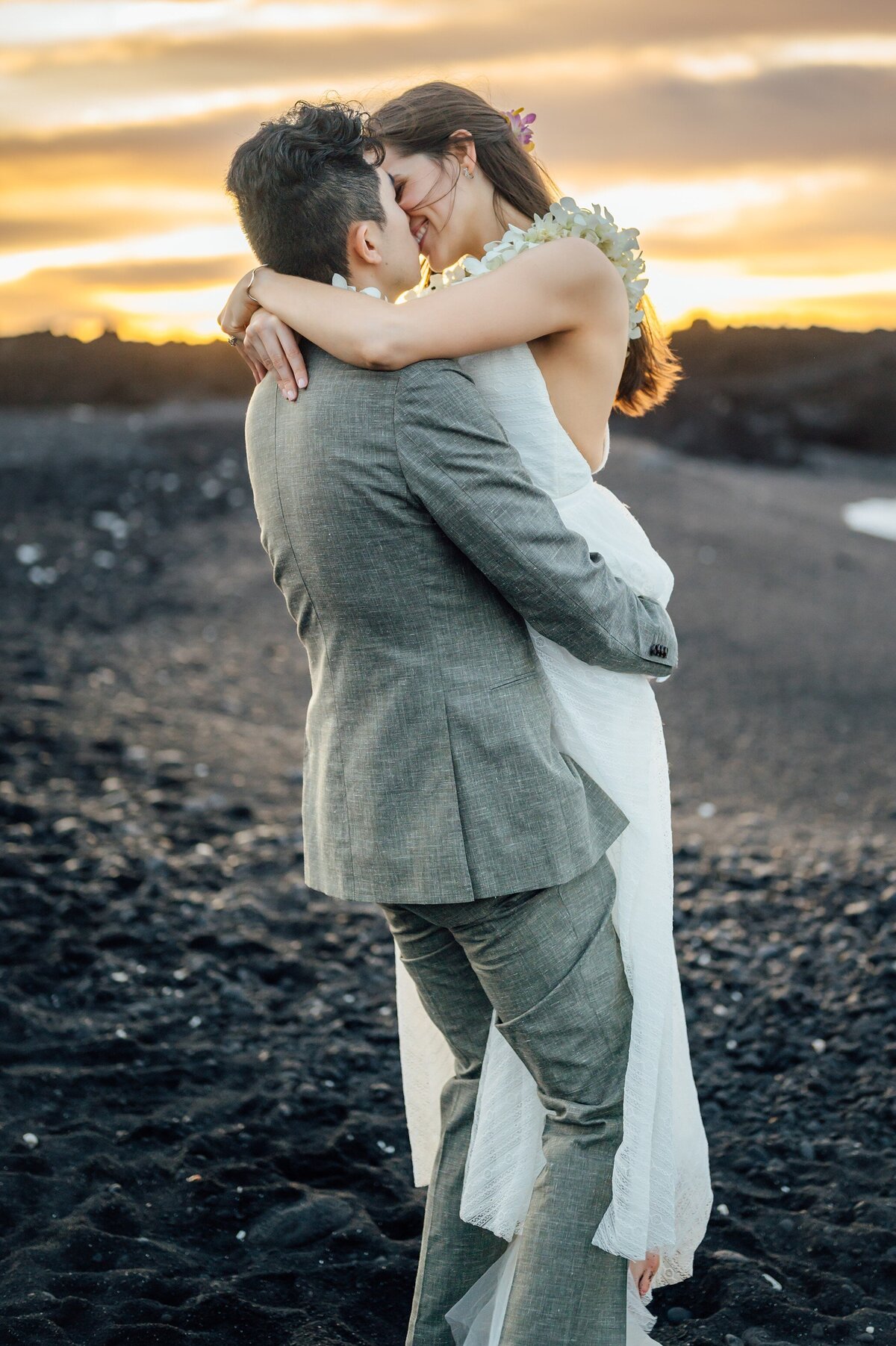 groom picks up bride for an embrace and a kiss