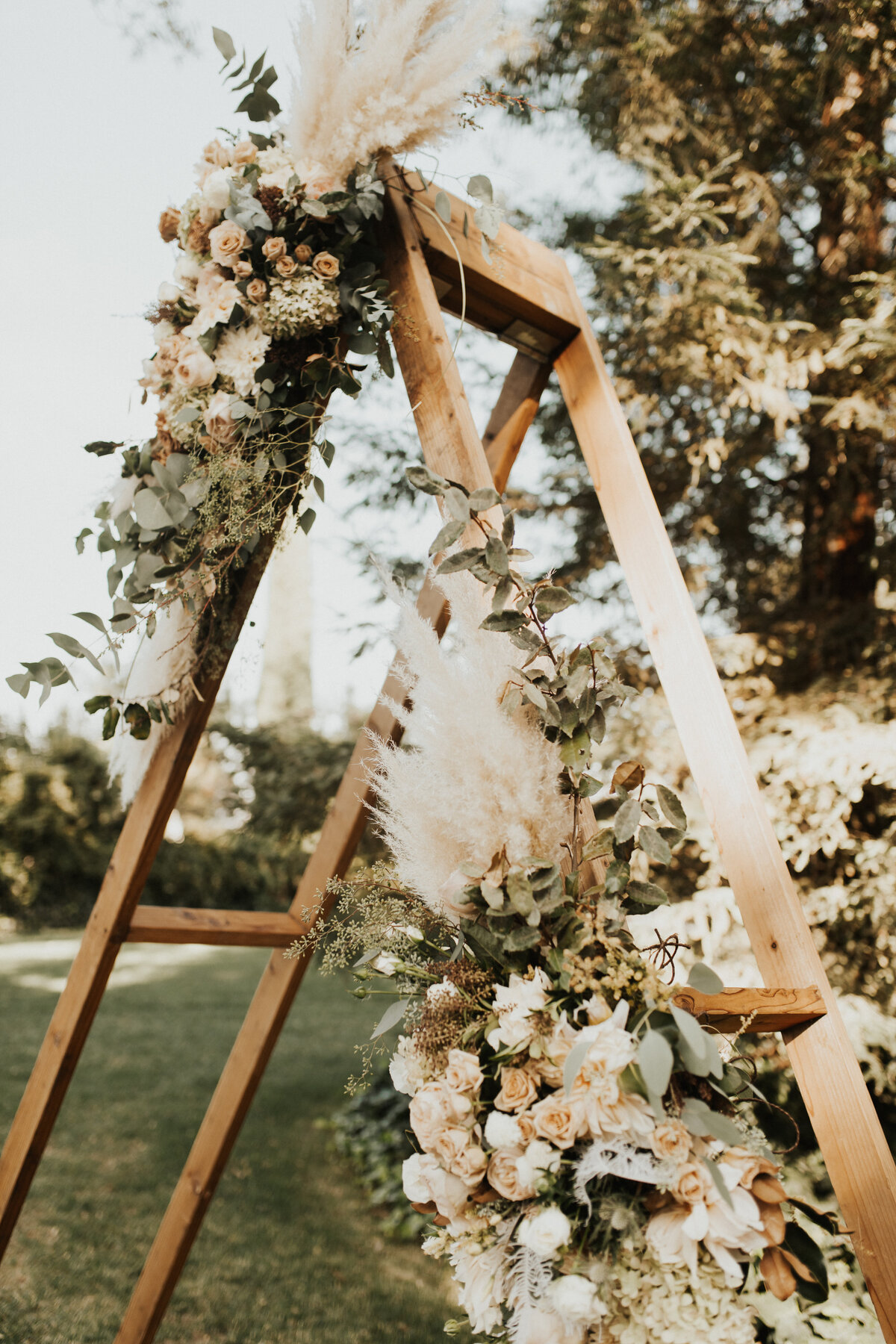wood triangle arch with flowers