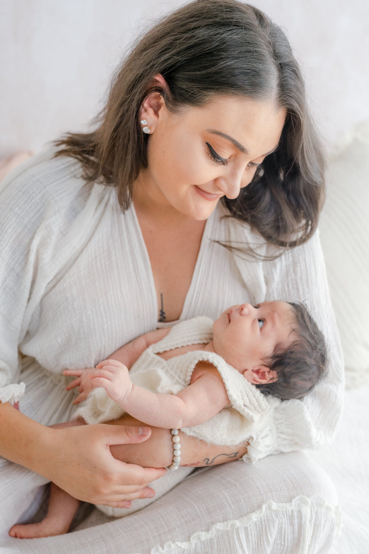 Mom cuddling baby during natural light Barrie newborn photography session 