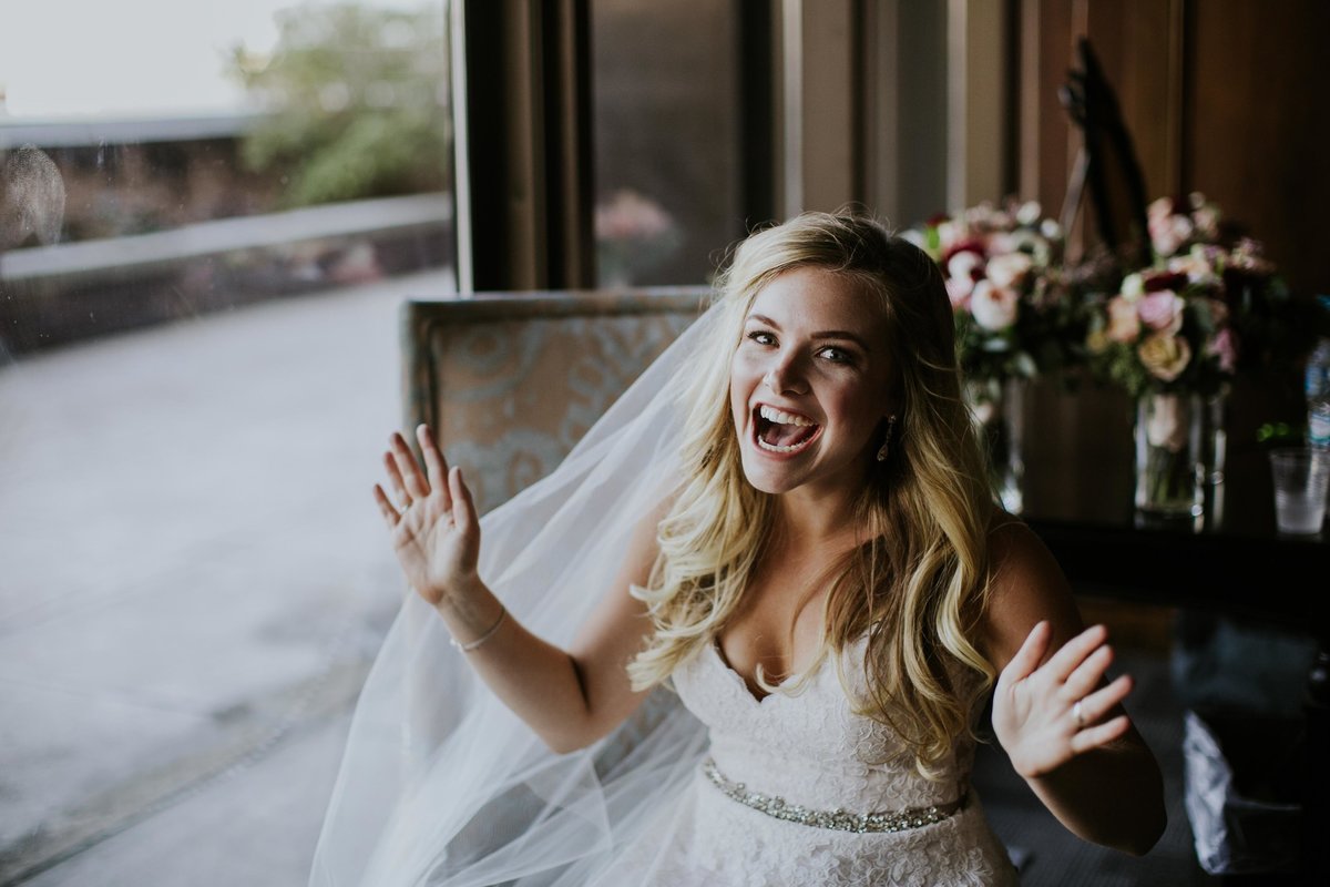 Bride shows excitement before rooftop wedding at Regions Tower JPS Events
